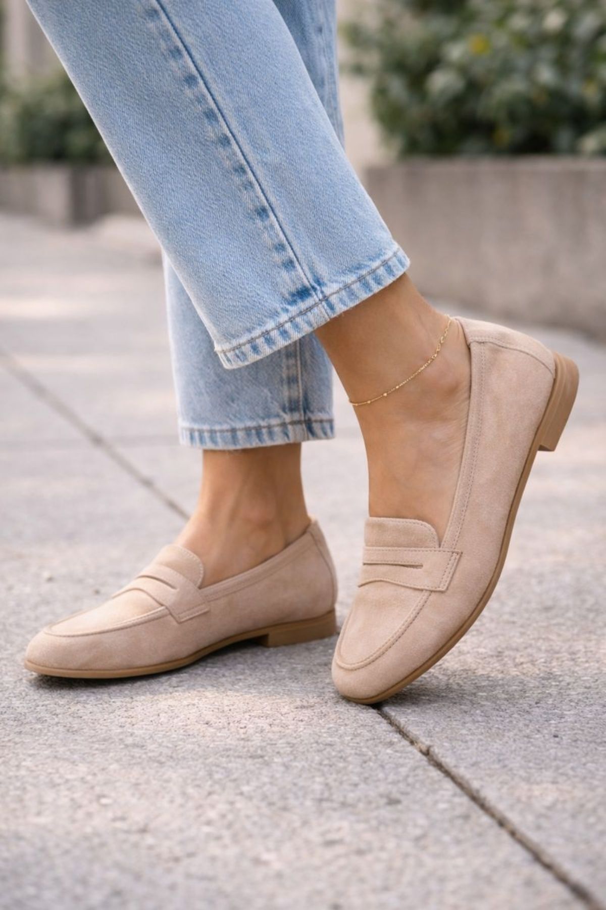 Close-up of neutral beige loafers styled with light blue cropped jeans, creating a comfortable yet polished casual look for everyday wear.