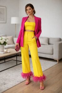 Bold yellow pantsuit with pink blazer for an extravagant wedding guest outfit