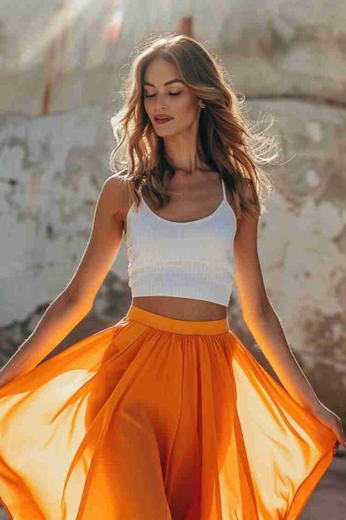 White crop top with high-waisted flowing skirt creating a slimmer waist and flattering summer silhouette.