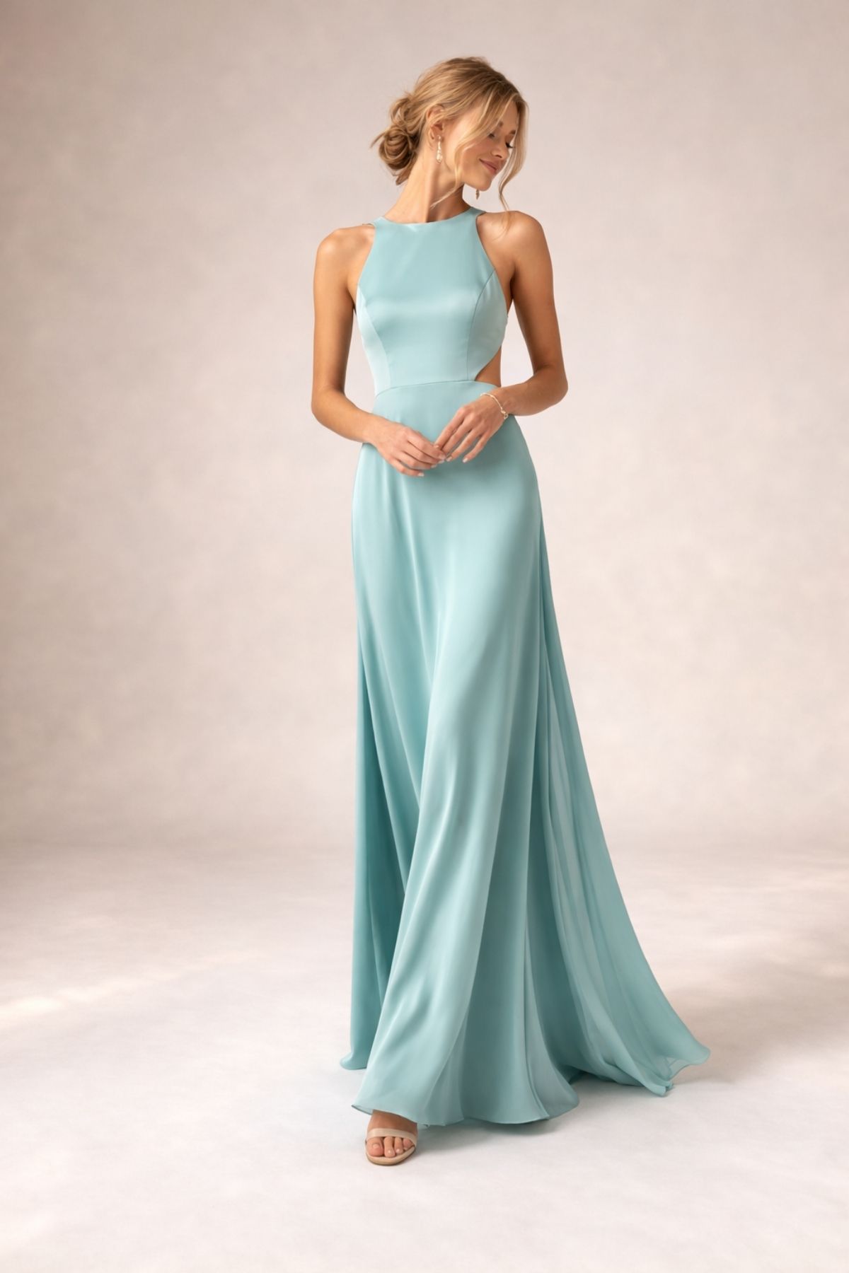 Elegant seafoam green bridesmaid dress with high neckline and flowing floor-length silhouette, ideal for a modern summer wedding 2026, photographed in a soft neutral studio setting.